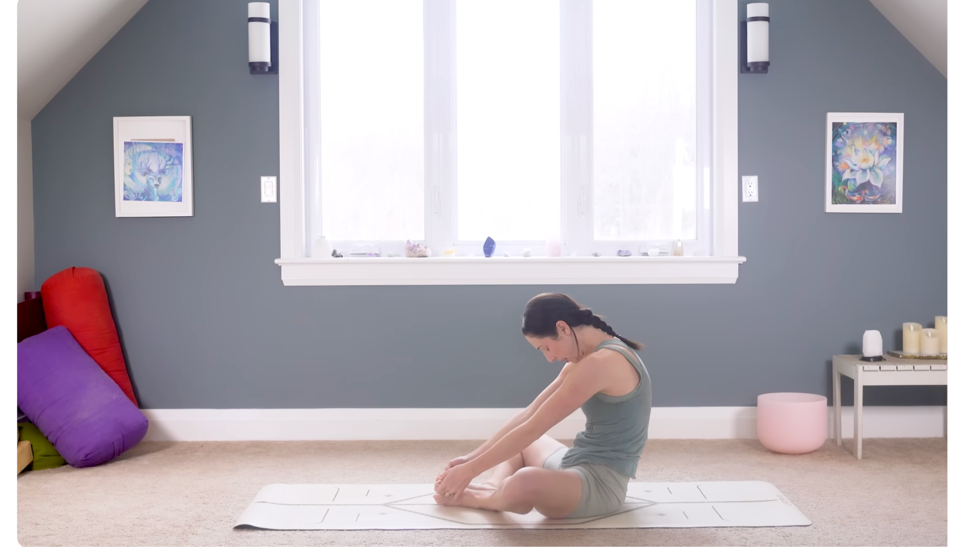 Woman sitting and rounding her back as she keeps her hands on her knees